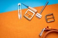Leather working or Leather craft. Orange tanned leather on leather craftman`s work desk . Working tools on a work table Royalty Free Stock Photo