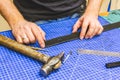 Leather workshop master holds a black belt