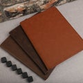 Leather Zipper Portfolio. Concept shot, top view, flap portfolio in brown colors and leather pen. Custom background flap portfolio Royalty Free Stock Photo