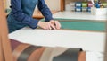 Leatherworker measuring and cutting leather in workshop. Royalty Free Stock Photo