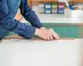 Leatherworker measuring and cutting leather in workshop. Royalty Free Stock Photo