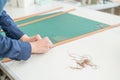 Leatherworker measuring and cutting leather in workshop. Royalty Free Stock Photo