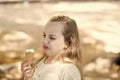 It leaves a bad taste in the mouth. Cute little girl dislike taste of ice cream. Small child licking ice cream with Royalty Free Stock Photo