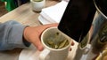 Tourist making coca leaves tea, Cusco, Peru, South America.