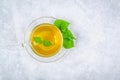 Leaves of fresh green nettle and a clear glass cup of herbal net Royalty Free Stock Photo