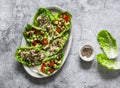 Leaves of mini roman salad stuffed with tuna, egg, tomato, avocado on a gray background, top view. Delicious appetizer, tapas, Royalty Free Stock Photo