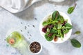 Leaves mix salad, spinach and arugula on a gray stone background.