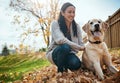 He leaves paw prints straight to my heart. an attractive young woman having fun with her dog on an autumn day in a Royalty Free Stock Photo