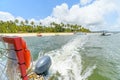 Leaving a beautiful beach on a tourist catamaran, Praia dos Carneiros beach