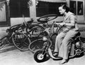 Leaving bicycles in the dust, a young woman fancies a miniature motorbike