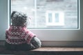 Leaving concept: Teddy bear is looking out of the window Royalty Free Stock Photo