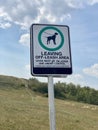 Leaving Off-Leash Area sign. Dogs must be under control on leash and under control.