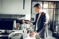 Mature economist taking his staff into box after leaving the office