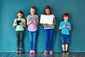 Leaving wireless technology in the hands of kids. Studio shot of a group of kids using wireless technology against a