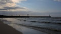 Leba beach afer rainy day, sun rays pass through the clouds, Poland