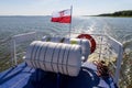 Leba, pomorskie / Polska ÃÂ¢Ã¢âÂ¬Ã¢â¬Å 14 lipca 2019 :Polish flag suspended on the stern of a small inland ship. A vessel floating on a Royalty Free Stock Photo