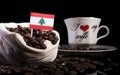 Lebanese flag in a bag with coffee beans on black