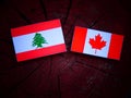 Lebanese flag with Canadian flag on a tree stump isolated