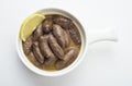 Lebanese starters of Makanek meat marinated, sausages fried in a metal pan isolated on white