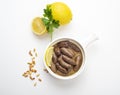 Lebanese starters of Makanek meat marinated, sausages fried in a metal pan isolated on white