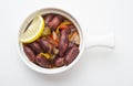 Lebanese starters of Sausage meat marinated, sausages fried in a metal pan isolated on white Royalty Free Stock Photo