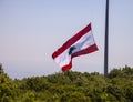 Rising Large Flag of Lebanon Over Green Hill