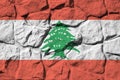 Lebanon flag depicted in paint colors on old stone wall closeup. Textured banner on rock wall background