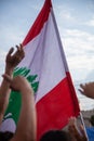 Lebanon Flag and protesters hands in Lebanese Civil Revolution