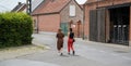 Lebbeke, Flanders - Belgium - Two attarctive teenage highschool girls walking through the village Royalty Free Stock Photo