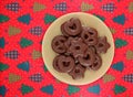 Spiced german biscuits with chocolate. In shape of pretzel, hearts and stars Christmas cookies on red tablecloth