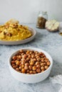 Leblebi Turkish delicacy of fried chickpeas in porcelain plate in kitchen, vertical food content, selective focus Royalty Free Stock Photo