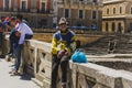 LECCE, ITALY APRIL 23, 2018 Senior man and young people in ancient centre, Roman amphitheatre of Lecce