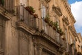 Close up of facade of baroque style building with and balcony in the town centre of Lecce, Puglia, Southern Italy.