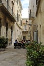 Tourists enjoying a food and drink in a street cafe restaurant in the popular city of Lecce in