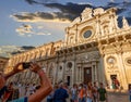 Lecce, Puglia, Italy. August 2021. The church of Santa Croce is the finest example of Lecce baroque. A tourist is photographing Royalty Free Stock Photo