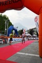 Sportsman arriving at the finish of `Lecco city - Resegone mountain` running marathon event.