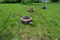 Sculpture of three spiders made of old tires walking on the green meadow. Ecological warning.