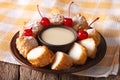 Leche frita and condensed milk, decorated with cherries close-up. horizontal