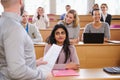 Lecturer and multinational group of students in an auditorium