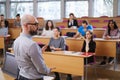 Lecturer and multinational group of students in an auditorium Royalty Free Stock Photo