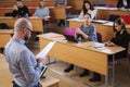 Lecturer and multinational group of students in an auditorium