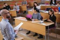 Lecturer and multinational group of students in an auditorium