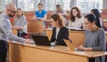 Lecturer and multinational group of students in an auditorium