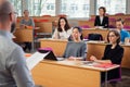 Lecturer and multinational group of students in an auditorium Royalty Free Stock Photo