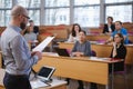 Lecturer and multinational group of students in an auditorium Royalty Free Stock Photo