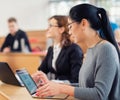 Lecturer and multinational group of students in an auditorium Royalty Free Stock Photo