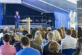 Lecturer Speaking In front of the Large Group of People. Royalty Free Stock Photo