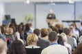 Lecturer Speaking In front of the Large Group of People