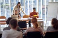 Lecturers with their assistant in front of group of people at seminar Royalty Free Stock Photo