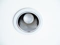 LED ceiling light. Downlight with light bulb on white ceiling background Royalty Free Stock Photo